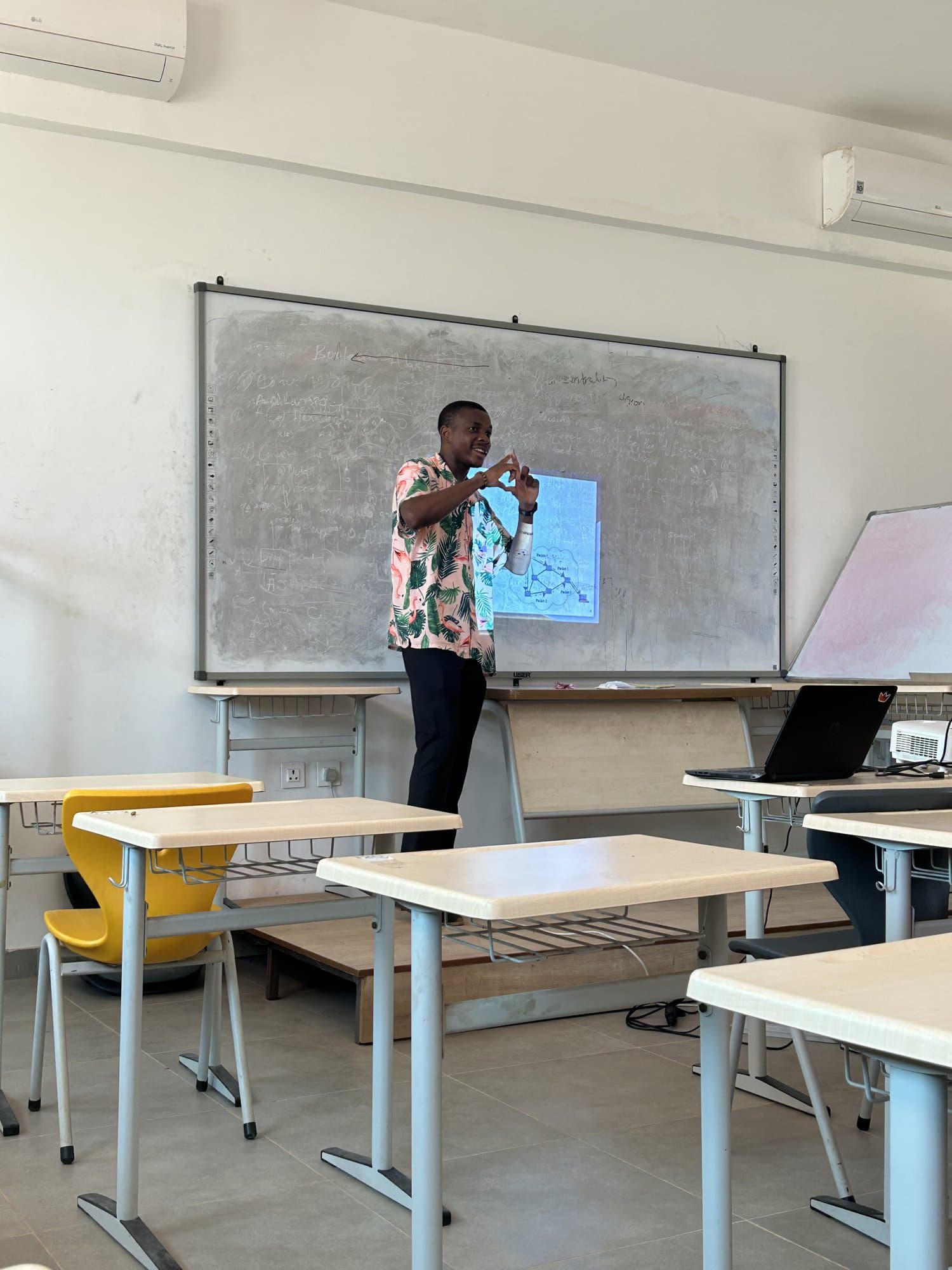 Jordan presenting beside a whiteboard