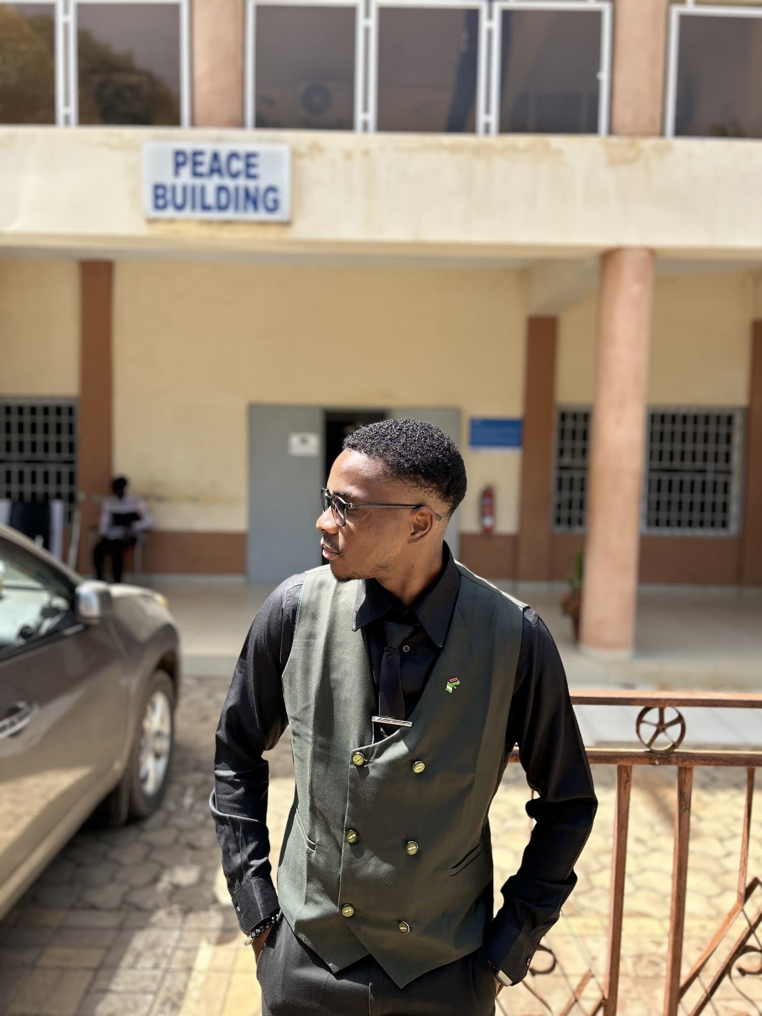 Jordan in a vest outside the Peace Building
